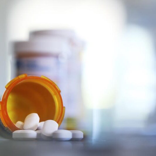Pills Pour Out Of Prescription Medication Bottle Onto Kitchen Counter chromatography drug testing